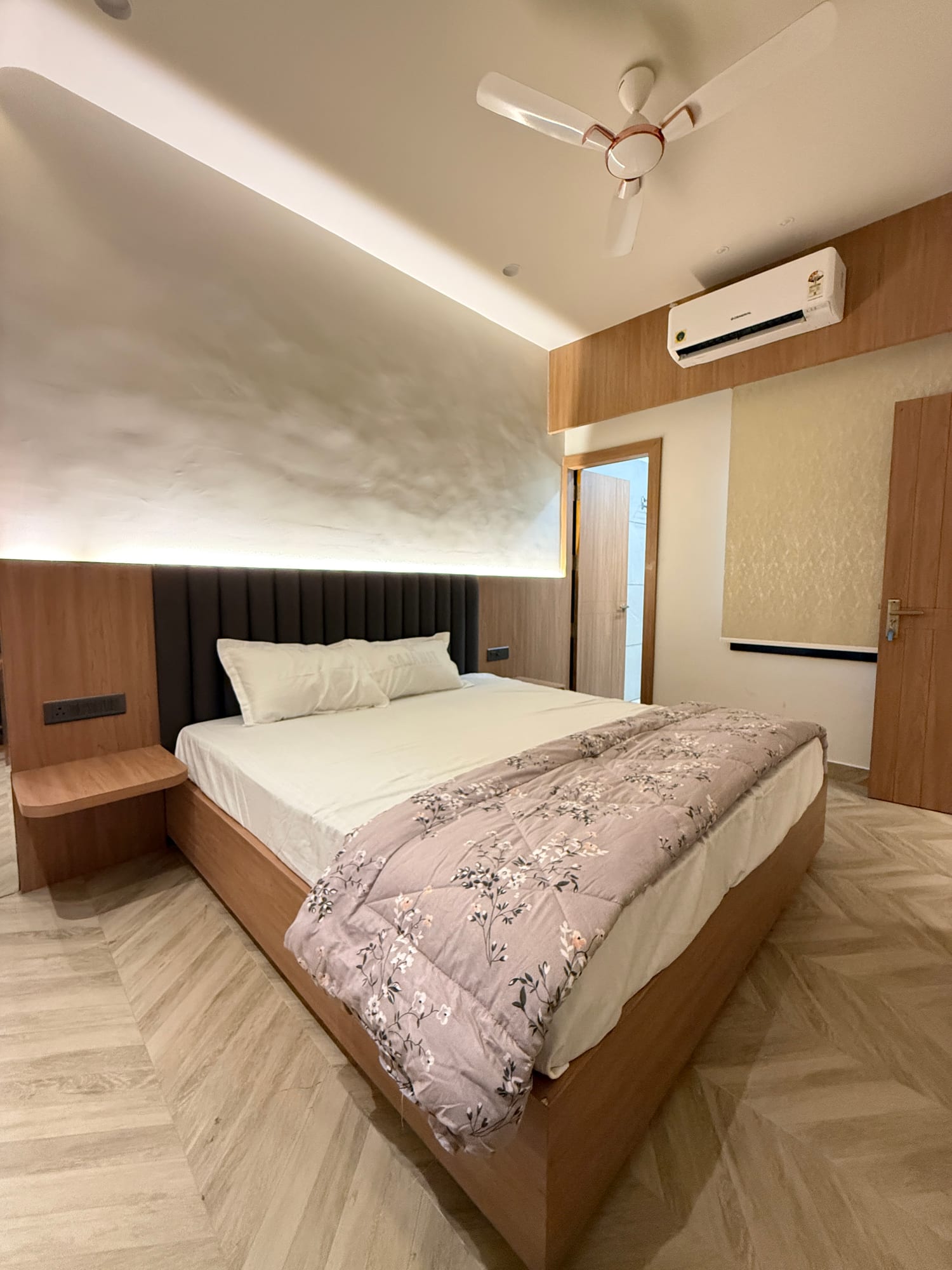 Deluxe room with channel-tufted headboard and AC at The Cosmo